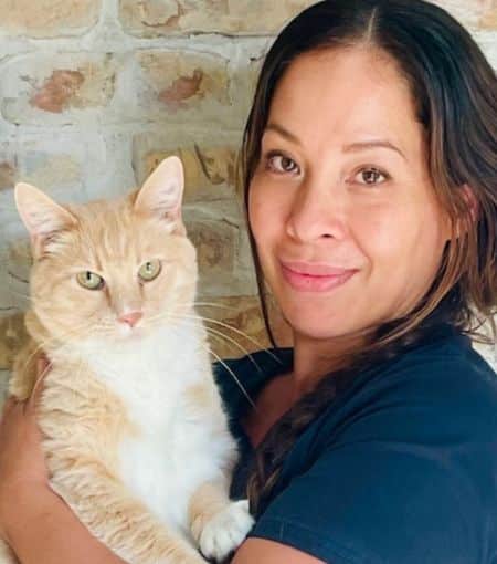Mariah holding light orange and white cat.
