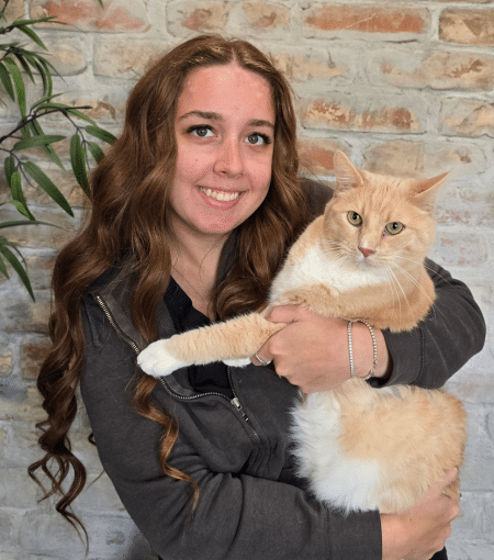 Mariah holding light orange and white cat.